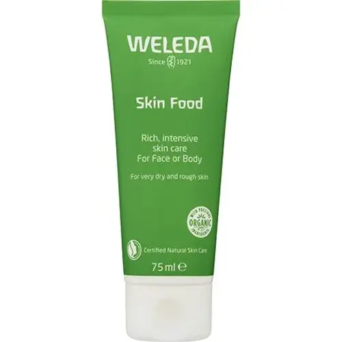 En grön och vit tub med ansiktskräm tillverkad av märket "Weleda" som heter "Skin Food"