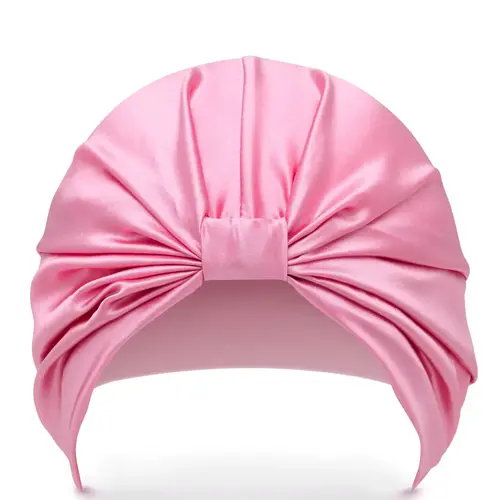 En rosa sovmössa tillverkad i siden av märket "Silke London"